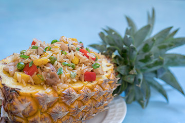 pineapple stuffed with fried rice, chicken and vegetables