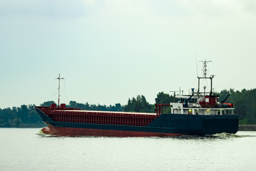 Blue cargo ship underway