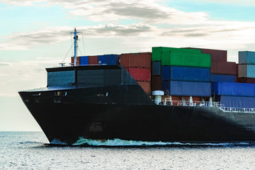 Black container ship underway