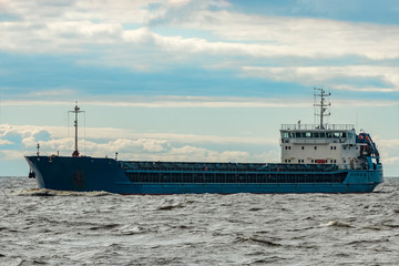 Blue cargo ship underway