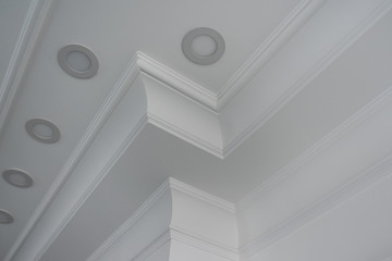 Fototapeta premium Ceiling moldings in the interior, detail of a angular ceiling skirting and lamps