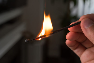 hand with burning match
