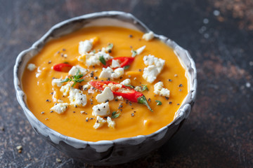 Roasted pumpkin and carrot soup with feta cheese and chili