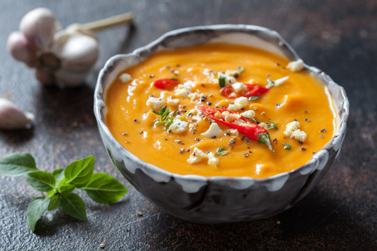 Roasted pumpkin and carrot soup with feta cheese and chili