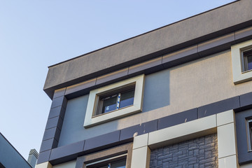 Perspective bottom shot of urban reinforced constructed modern building with blue sky in Izmir at Turkey