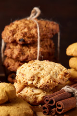 Christmas concept with cookies and decorations on a log over wooden background, selective focus