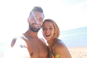 Happy loving couple enjoy tropical beach.