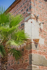 sun clock mounted on a old mosque