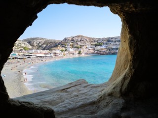 A view to a beautiful beach from a cave