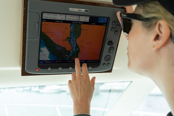 Woman on cruise boat working the navigation system