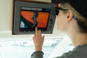 Woman on cruise boat working the navigation system