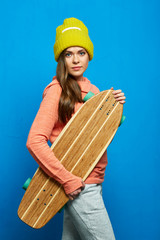 Girl holding wooden skateboard, longboard.