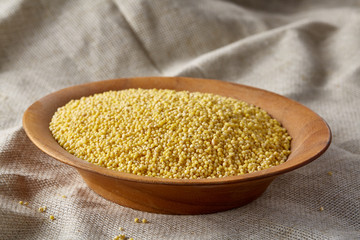 Two bowls of millet on a wooden background, top view, close-up, selective focus.