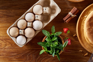 Fresh mint leaves in a bowl on wooden table, close-up, selective focus, shallow depth of field.