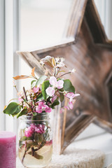 Pink Apple Blossoms in Mason Jar next to Wooden Star