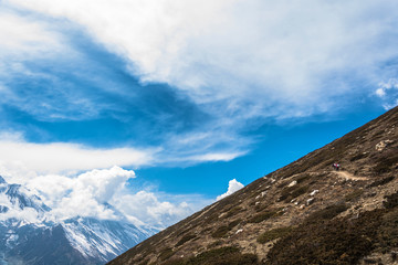The mountain slope on the background of the cloudy sky, Nepal.