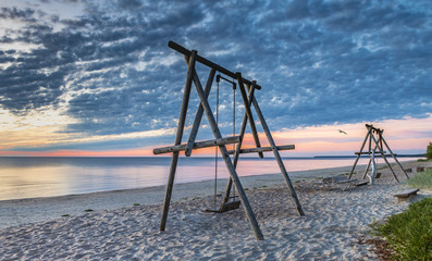 Coastal landscape at colorful dawn, sandy beach of the Baltic Sea