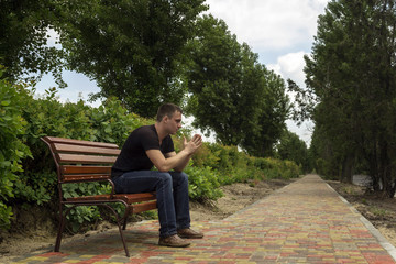 thoughtful guy on a bench