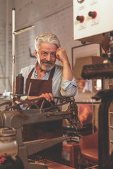 An elderly man in a workshop