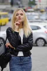Fototapeta na wymiar Pretty blonde girl posing in the street