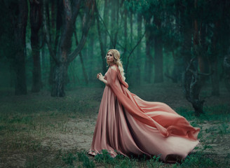 A mysterious blonde girl in a long pink dress with a train and a raincoat that flutters in the...