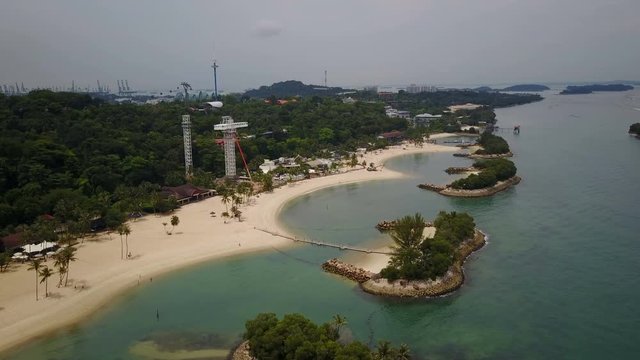 Establishing aerial shot of the popular Sentosa island theme park and beach in Singapore