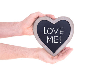 Fototapeta premium Adult holding heart shaped chalkboard