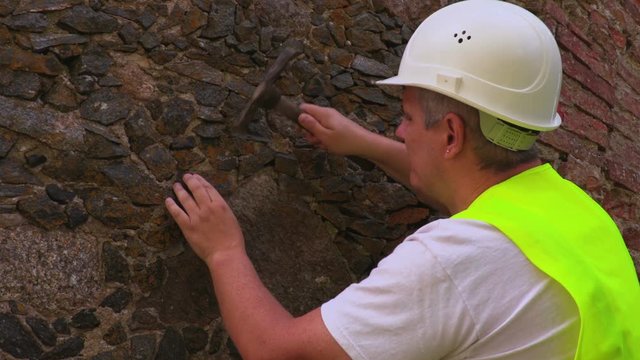 Engineer take samples of old brick wall