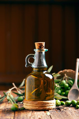 Fototapeta na wymiar Bottle of oilve oil on wooden table