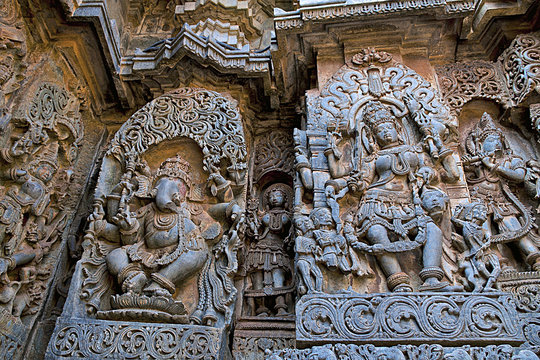 Ornate wall panel reliefs depicting dancing Ganesha on the left and Goddess Kali on the right, Hoysaleshwara temple, Halebidu, Karnataka