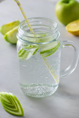 Refreshing water with fruit in a glass jar