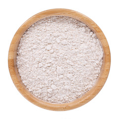 Whole wheat flour in wooden bowl isolated on white. Top view.