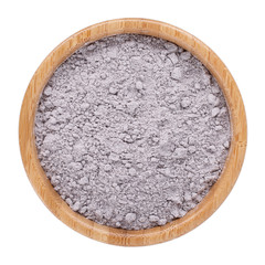 Black rice flour powder in wooden bowl isolated on white. Top view.
