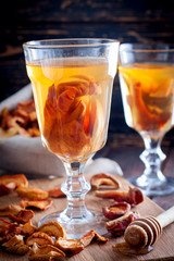 Compote of dried fruits with ingridients on rustic wooden background