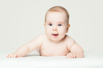 Cute baby lying on white background (2 months old)