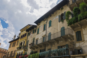 Fototapeta na wymiar Verona, Italy Piazza delle Erbe buildings. Day view of traditional houses with balconies at Market square.