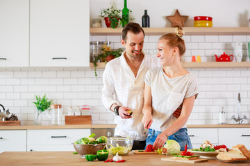 Photo of beautiful couple in love preparing breakfast in kitchen