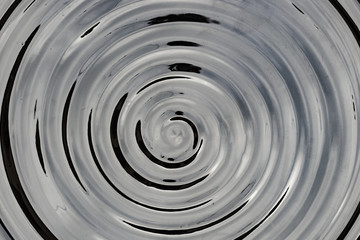 Dark glossy ceramic glass water surface spiral circle pattern backdrop spiral