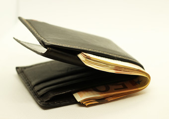 Money in your wallet. Denominations look out of the purse. Paper euros.