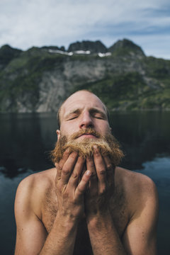 Man washing his beard at lake