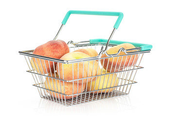 Fresh ripe Saturn peaches in a shopping basket isolated on white background.