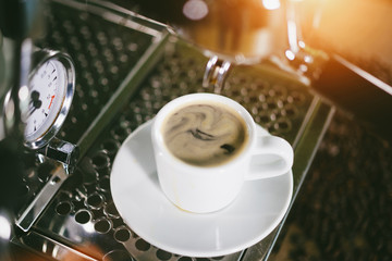 Espresso out of classic coffee machine into coffee cup