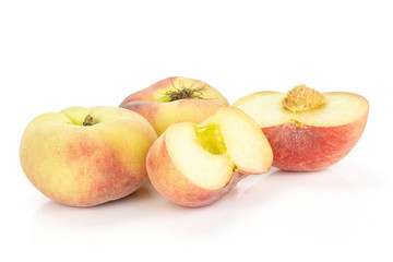 Two fresh ripe Saturn peaches and two sliced halves isolated on white background.