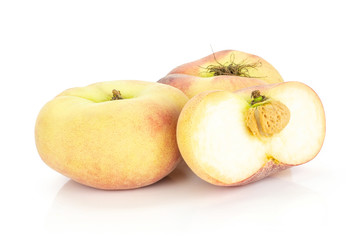 Two fresh ripe Saturn peaches with one sliced half isolated on white background.
