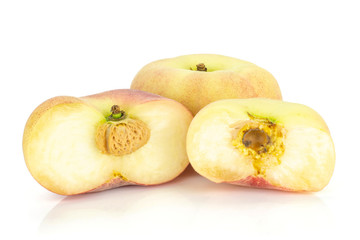 One fresh ripe Saturn peach with two halves isolated on white background.