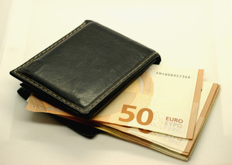 Money in your wallet. Denominations look out of the purse. Paper euros.