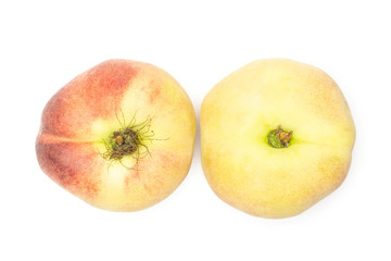 Two fresh ripe Saturn peaches flatlay isolated on white background.
