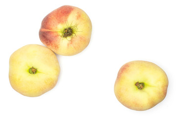 Three fresh ripe Saturn peaches top view isolated on white background.