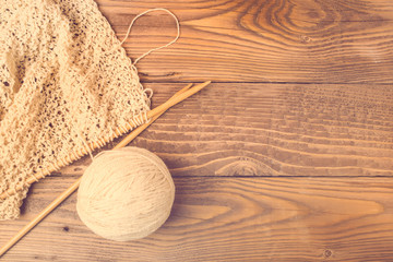 Natural knitting wool. Knitting needles.Leisure hobby concept. Ball of wool on wooden background....
