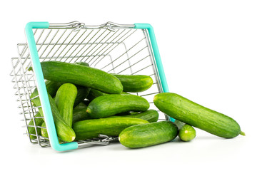 Fresh green mini cucumbers out a shopping basket isolated on white background.